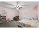 Cozy bedroom with flamingo themed bed and floral accents on the pink walls at 206 Bonville Dr, Davenport, FL 33897