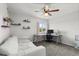 Bedroom with a desk, shelving, carpet, and a ceiling fan at 206 Bonville Dr, Davenport, FL 33897