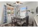 Cozy dining room featuring a dark wood table set, natural light, and backyard view at 206 Bonville Dr, Davenport, FL 33897