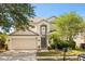 Charming two-story home with a well-manicured lawn and attached two-car garage at 206 Bonville Dr, Davenport, FL 33897