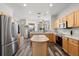 Spacious kitchen featuring wood cabinets, stainless steel appliances, and hardwood flooring at 206 Bonville Dr, Davenport, FL 33897
