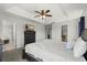 Bright main bedroom featuring a tray ceiling, carpet, and dark wood furniture at 206 Bonville Dr, Davenport, FL 33897