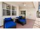 Outdoor patio featuring comfortable blue seating and ceiling fan at 206 Bonville Dr, Davenport, FL 33897