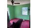 Bedroom with two windows, green walls, and stained red carpet at 2117 Lemon St, Haines City, FL 33844
