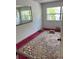 Bedroom with two windows, a mirror, and patterned carpet at 2117 Lemon St, Haines City, FL 33844