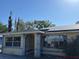 Modest home with solar panels and an enclosed front porch at 2117 Lemon St, Haines City, FL 33844