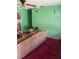 Cozy living room featuring green walls, patterned sofa, and a vintage ceiling fan at 2117 Lemon St, Haines City, FL 33844