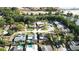 A captivating aerial view of a neighborhood featuring lush greenery, tranquil waterways, and well-maintained homes with inviting pools at 2227 Coventry Dr, Winter Park, FL 32792