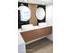 Bright bathroom boasts floating double sink with wood drawers and unique, modern fixtures at 2227 Coventry Dr, Winter Park, FL 32792