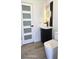 Modern half bath featuring sleek fixtures, a stylish vanity, and a round mirror at 2227 Coventry Dr, Winter Park, FL 32792
