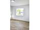 Bright bedroom with a window offering an outdoor view and featuring light wood flooring at 2227 Coventry Dr, Winter Park, FL 32792