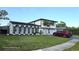 Charming two-story home with a lush lawn, complemented by mature landscaping at 2227 Coventry Dr, Winter Park, FL 32792