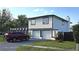 Exterior shot showing the home's two car garage, manicured lawn, and two story construction at 2227 Coventry Dr, Winter Park, FL 32792