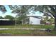 Exterior of a cozy home with mature trees, a manicured lawn, and inviting curb appeal at 2227 Coventry Dr, Winter Park, FL 32792