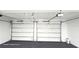 Spacious two car garage with automatic doors and black epoxy flooring provides safe parking and utility storage at 2227 Coventry Dr, Winter Park, FL 32792