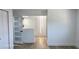 Hallway leading to various rooms with white walls and flooring, and modern doors with multi-pane glass at 2227 Coventry Dr, Winter Park, FL 32792