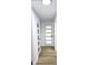 Hallway featuring several white wooden doors with glass panels and modern black hardware at 2227 Coventry Dr, Winter Park, FL 32792