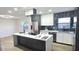 Modern kitchen featuring an island with cooktop, sleek white cabinets, and stainless steel appliances at 2227 Coventry Dr, Winter Park, FL 32792