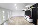 A bright living room with modern decor, a stylish TV, and beautiful light wood flooring at 2227 Coventry Dr, Winter Park, FL 32792