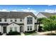Charming two-story townhome with a well-maintained lawn, tile roof, and beautiful landscaping at 228 Captiva Dr, Davenport, FL 33896