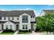 Beautiful two-story townhome showcasing a tile roof and vibrant landscaping against a blue sky at 228 Captiva Dr, Davenport, FL 33896