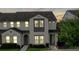 Elegant two-story townhome featuring stylish architectural details and manicured front yard at 228 Captiva Dr, Davenport, FL 33896