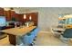 Open-concept kitchen featuring a large island with seating, pendant lighting, and granite countertops at 228 Captiva Dr, Davenport, FL 33896
