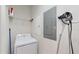 Bright laundry room features a white washer, dryer, wire shelving, and a convenient storage unit, optimizing space and functionality at 228 Captiva Dr, Davenport, FL 33896