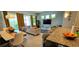 Comfortable open-concept living and dining area filled with natural light, leading to a screened-in pool at 228 Captiva Dr, Davenport, FL 33896
