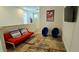 Bright living room with modern furniture, including a cozy futon, egg chairs and a colorful rug for stylish relaxation and entertainment at 228 Captiva Dr, Davenport, FL 33896