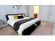 Well-lit bedroom featuring a modern bed and decor, complemented by a view into the bathroom with a double vanity at 228 Captiva Dr, Davenport, FL 33896