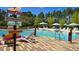 Relaxing poolside with colorful signs, sun loungers, inviting guests to relax, swim and soak up the sun at 228 Captiva Dr, Davenport, FL 33896