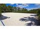 Outdoor sand volleyball court surrounded by greenery and blue skies, offering recreation and leisure at 228 Captiva Dr, Davenport, FL 33896