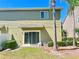 Backyard with a sliding glass door, green lawn and tropical palm trees around the yard at 2305 Chatham Place Dr, Orlando, FL 32824