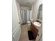 Bathroom with tiled floor, shower-tub combo with curtain, and vanity with sink at 2305 Chatham Place Dr, Orlando, FL 32824