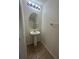 Small bathroom with pedestal sink, tile flooring, and essential fixtures, offering a clean and minimalist design at 2305 Chatham Place Dr, Orlando, FL 32824