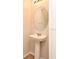 Charming pedestal sink with oval mirror in a well-lit half bathroom at 2305 Chatham Place Dr, Orlando, FL 32824