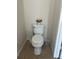 Compact toilet with a decorative flower pot, emphasizing the bathroom's practical and efficient use of space at 2305 Chatham Place Dr, Orlando, FL 32824