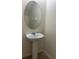 Close-up of a pedestal sink with a mirror, showcasing the bathroom's simple and functional design at 2305 Chatham Place Dr, Orlando, FL 32824