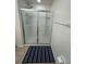 Bathroom featuring a glass shower with a blue striped rug and a towel rack at 2305 Chatham Place Dr, Orlando, FL 32824