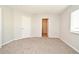 Bedroom featuring neutral carpeting, walk-in closet, and interior door at 2305 Chatham Place Dr, Orlando, FL 32824