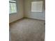 Bright bedroom featuring carpet, two windows, and neutral walls, perfect for relaxation at 2305 Chatham Place Dr, Orlando, FL 32824