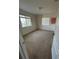 Carpeted bedroom featuring a window with blinds, creating a bright and airy space at 2305 Chatham Place Dr, Orlando, FL 32824
