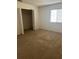 Bedroom with closet and window showcasing the simple, carpeted floors, and neutral walls creating a cozy space at 2305 Chatham Place Dr, Orlando, FL 32824