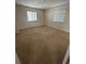 Bedroom with two windows and carpeted flooring, offering a bright and comfortable space at 2305 Chatham Place Dr, Orlando, FL 32824