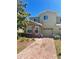 Inviting two-story townhome featuring stone accents, a one-car garage, and a brick-paved driveway at 2305 Chatham Place Dr, Orlando, FL 32824