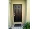 Solid black front door with a modern handle set and a small welcome mat at 2305 Chatham Place Dr, Orlando, FL 32824