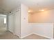 Hallway boasts neutral carpeting, two closets, and recessed lighting at 2305 Chatham Place Dr, Orlando, FL 32824