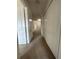 Hallway view with carpet and white closets, enhancing the home's storage and layout at 2305 Chatham Place Dr, Orlando, FL 32824