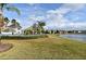 Lakefront view with lush green grass, community pool and neighboring houses at 2305 Chatham Place Dr, Orlando, FL 32824